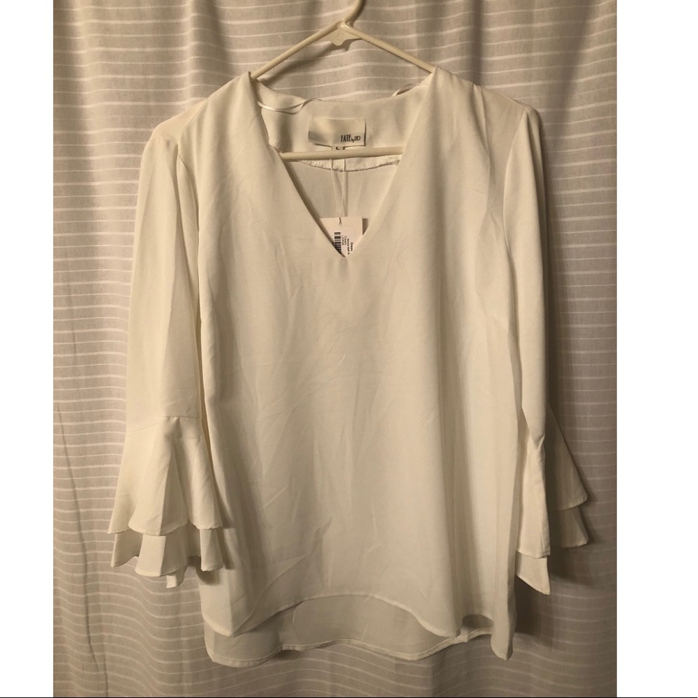 White ruffle sleeve top. NWT